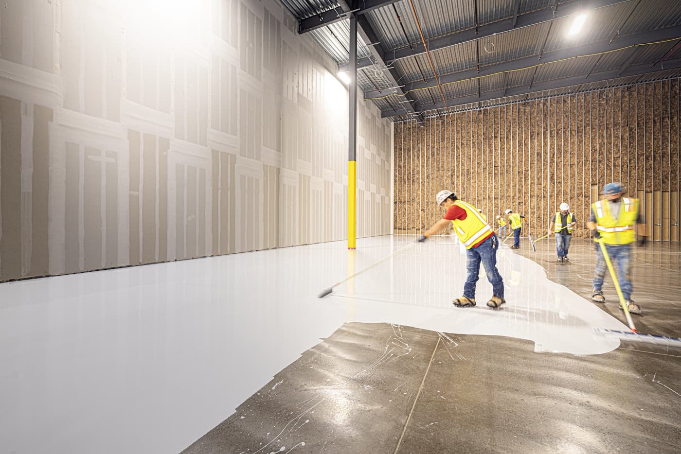 Contractor finishing a polished epoxy floor in an Ottawa garage